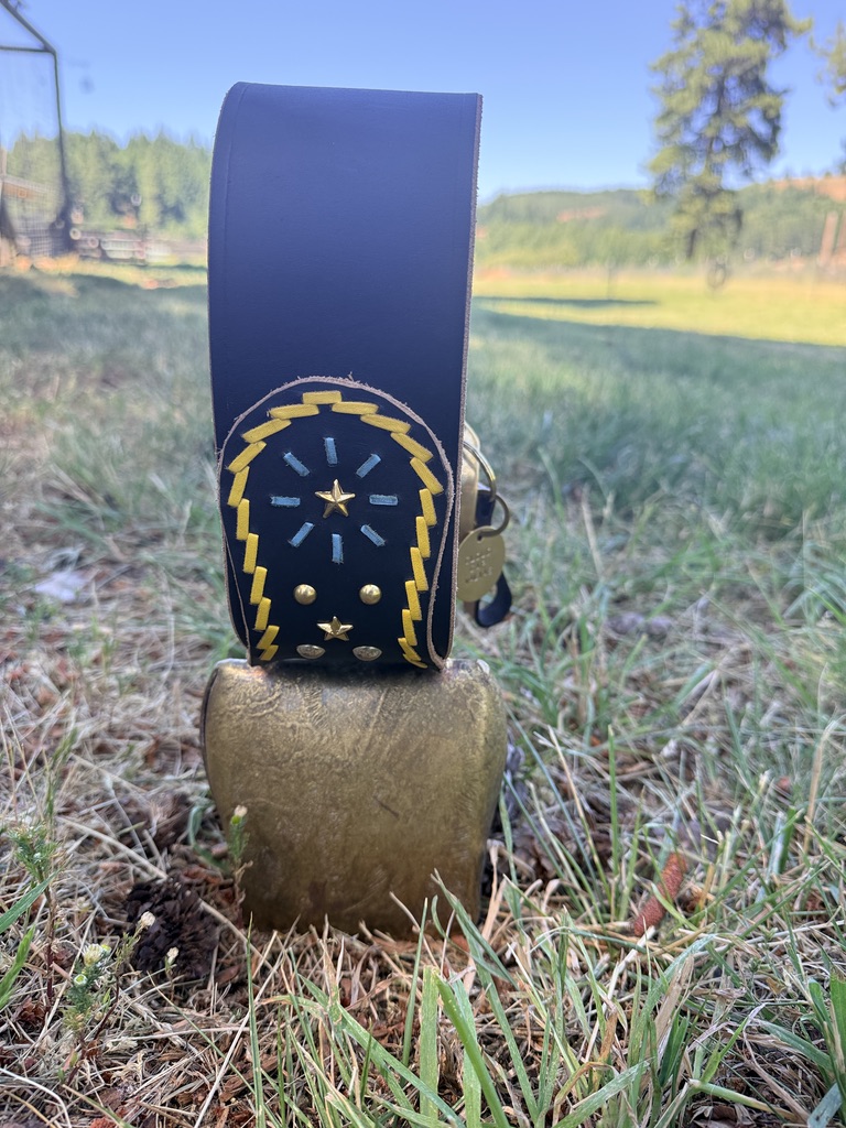 A traditional hand-tooled Swiss bell with a decorative studded leather strap, awarded to a top-graded Valais Blacknose sheep